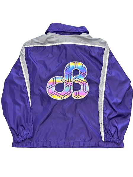 dB Purple quarter-zip windbreaker back with large reflective patch illuminated
