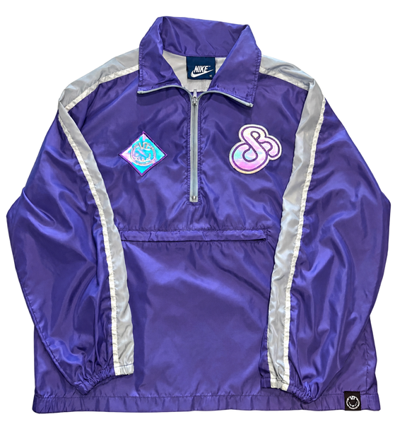 dB Purple quarter-zip windbreaker front with reflective patches illuminated