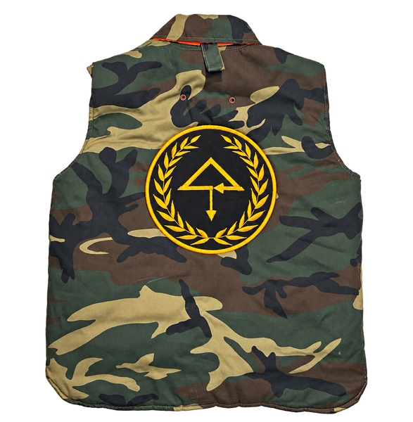 Back of OTT CaMo Hunters Vest with large black and gold embroidered OTT emblem