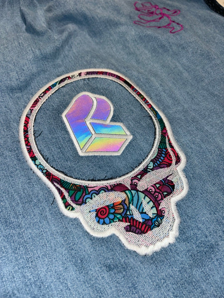 Close-up of reflective PL logo centered inside embroidered skull